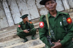 Soldiers pass their time as they guard the city in Lashio township