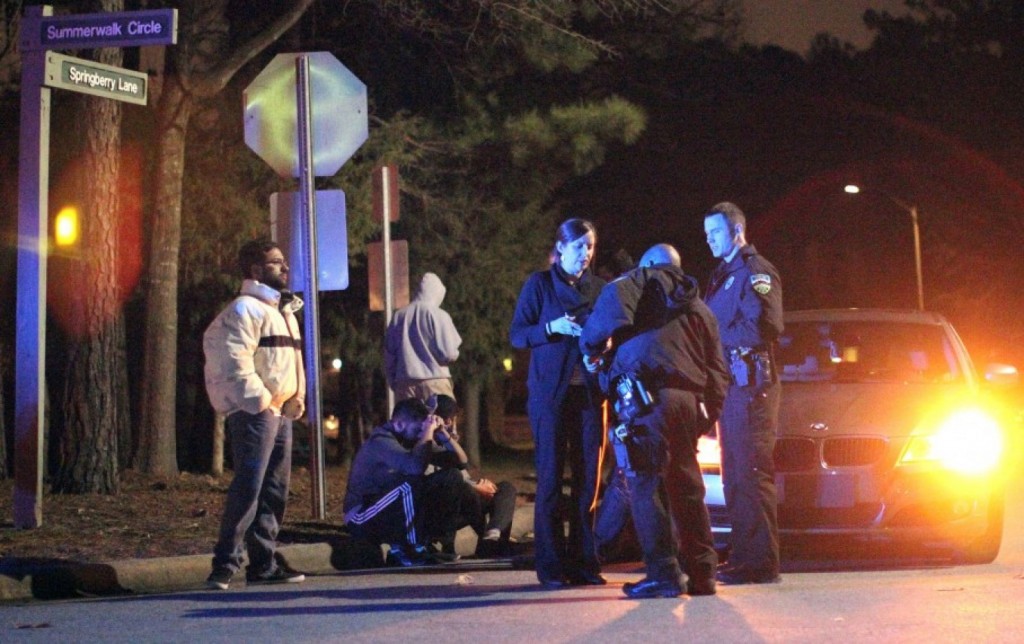 Chapel Hill police officers investigate the scene of three murders in Chapel Hill, N.C. (The News & Observer, Al Drago)