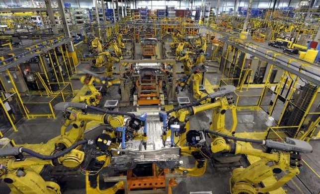 Robotic arms rivet floor panels together at Ford's Kansas City Assembly Plant where the new aluminum intensive Ford F-Series pickups are built in Claycomo, Missouri May 5, 2015. REUTERS/Dave Kaup