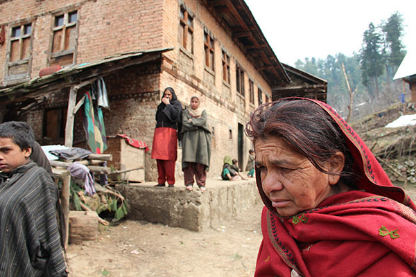 Roshni Jan, widow of Juma Khan, 38, outside her home. Image by Talal N. Ansari.