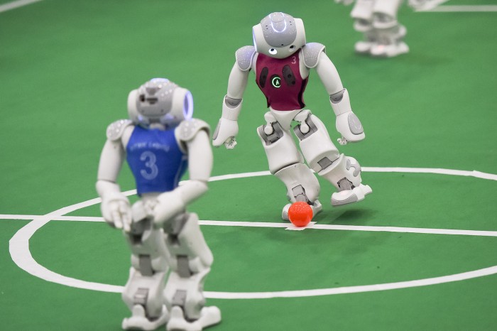 Little robots compete for the 2015 RoboCup in tiny soccer match. Photo: ZHANG DUAN/XINHUA PRESS/CORBIS