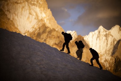 Expedition members meander between crevasses with the Gasherbrum IV massif visible in the background. PHOTO: DAVID KASZLIKOWSKI