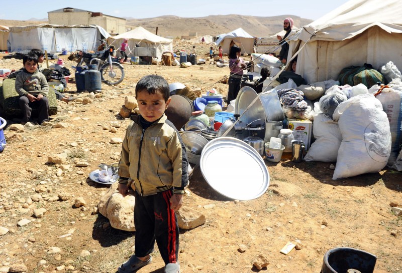 A Syrian refugee child who fled the violence from the Syrian town of Flita, near Yabroud, poses for a photograph at the border town of Arsal in Bekaa Valley, Lebanon situated along the border with Syria