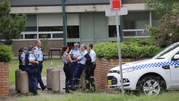 Police gather outside Woolooware High School, which received a bomb threat. Photo: John Veage