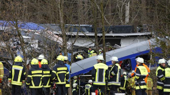 Rescue personnel stand in front of two trains that collided head-on near Bad Aibling, southern Germany, Tuesday, Feb. 9, 2016. Several people have been killed and dozens were injured. (AP Photo/Matthias Schrader)
