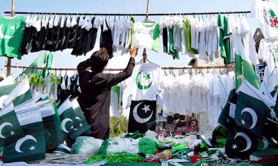 A vendor sells national flags of all shapes and sizes in Islamabad. Photo: APP