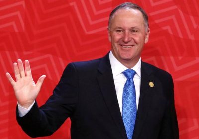 New Zealand's Prime Minister John Key waves to photographers during the APEC (Asia-Pacific Economic Cooperation) Summit in Lima, Peru, November 20, 2016. REUTERS/Mariana Bazo/File photo