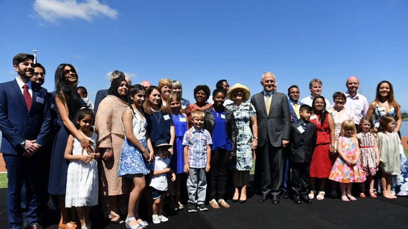 Malcolm Turnbull poses with Australia's newest citizens after a ceremony in Canberra. Photo: AAP