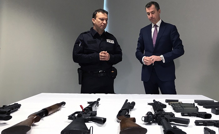 Justice Minister Michael Keenan (right) examines a range of weapons after announcing a new national gun amnesty in Canberra today. Picture: AAP
