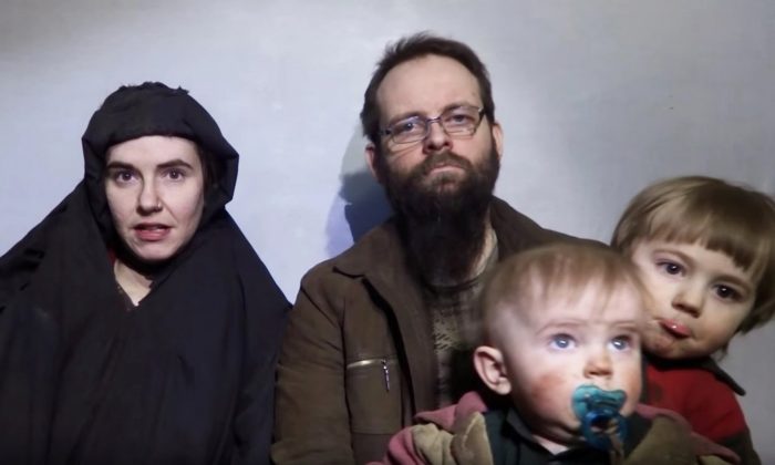 A still image from a video posted by the Taliban on social media on 19 December 2016 shows American Caitlan Coleman, left, speaking next to her husband, Joshua Boyle, and their two sons. Photograph: Handout/Reuters