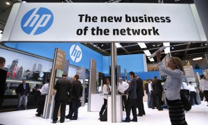 A visitor takes a photo with a tablet in front of a Hewlett-Packard (HP) stand at the Mobile World Congress in Barcelona