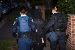 A women policers detaining a woman