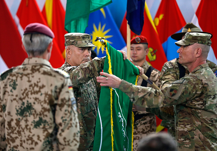 US General John Campbell, centre, folds the flag during the ceremony in Kabul.