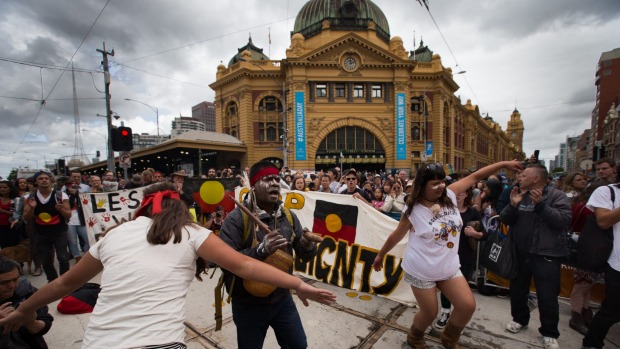 Hundreds of Invasion Day protestors march at the back of the Australian Day Parade in Melbourne's CBD. Photo: Jason South