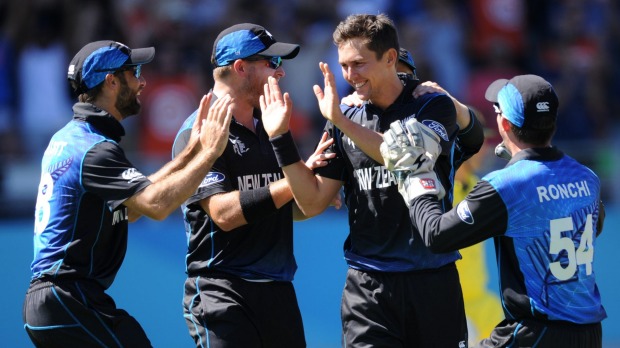 New Zealand's Trent Boult is congratulated by teammates after removing Mitchell Marsh, one of the Black Caps fast bowler's five scalps. Photo: AP