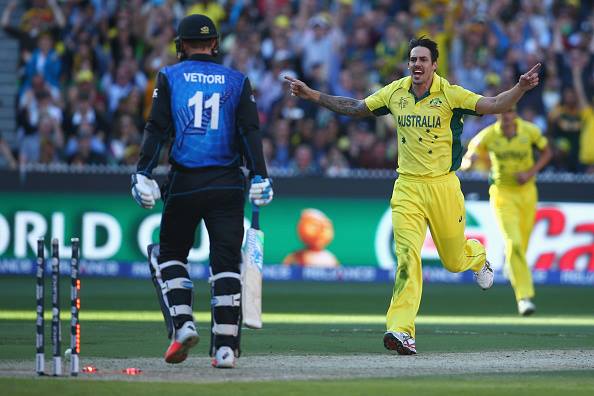 Australia's Mitchell Johnson, right, celebrates after taking the wicket of New Zealand’s Daniel Vettori, left, during the Cricket World Cup final in Melbourne, Australia.