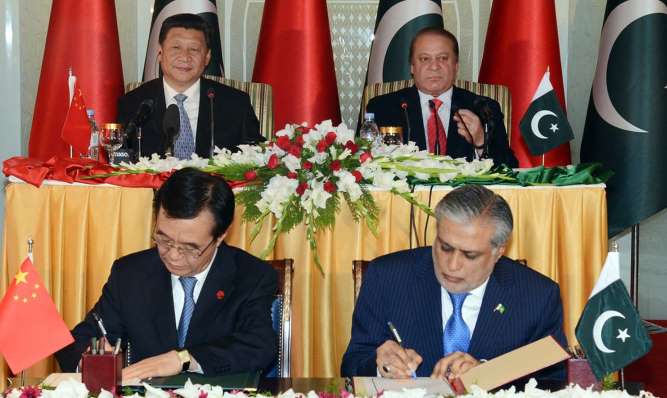 Xi Jinping, Nawaz Sharif look on as Pakistani Finance Minister Ishaq Dar and a Chinese official sign an MoU at PM House in Islamabad. — APP