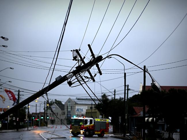 This power pole on the Princess Highway in Sydenham is one of many to come down in the wind. Photo: John Grainger