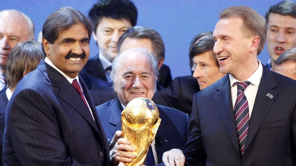 Officials from Qatar (left) and Russia (right) celebrate being awarded the right to host the World Cup