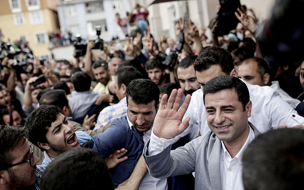 Selahattin Demirtas, right, co-chair of the Peoples' Democratic Party (HDP) at a polling station in Istanbul (AFP)