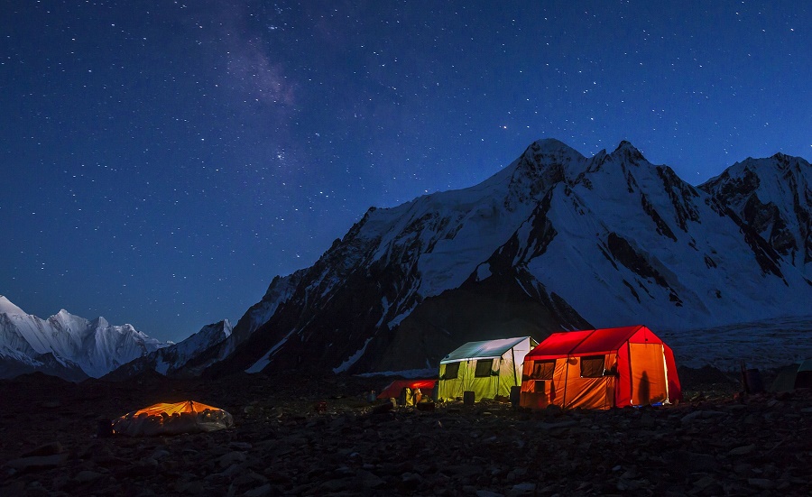 The porters’ tent at K2’s base camp is just a tarpaulin stretched over the stones, left, while the other tents belong to expedition members. PHOTO: DAVID KASZLIKOWSKI