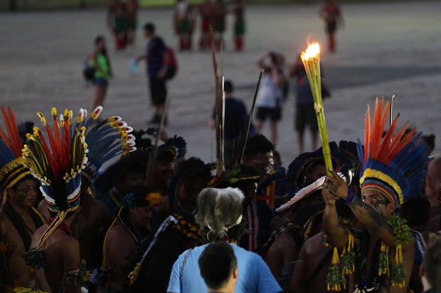 Manoti Indians light up a torch with the sacred fire of the World Indigenous Games in Palmas, Brazil, Thursday, Oct. 22, 2015. (AP Photo/Eraldo Peres)
