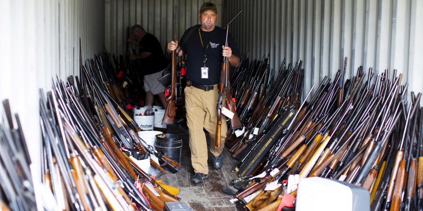 guns ammunition gun control firearms Chesterfield County Sheriff's lieutenant David Lee removes rifles from a shipping container as he and other officers sort through thousands of guns found in the home and garage of Brent Nicholson, in Pageland, South Carolina, November 10, 2015. Photo: REUTERS/Jason Miczek