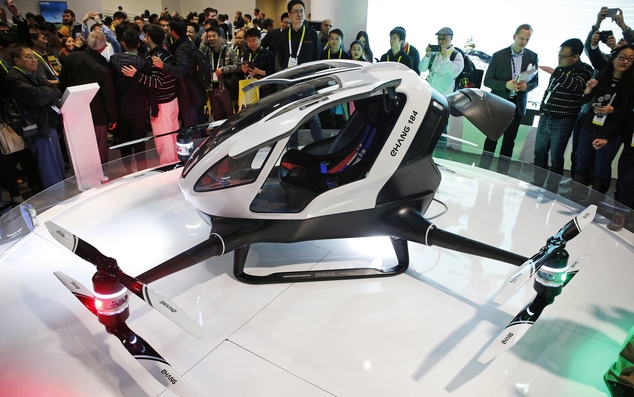 People crowd around the EHang 184 autonomous aerial vehicle at the EHang booth at CES International, Wednesday, Jan. 6, 2016, in Las Vegas.