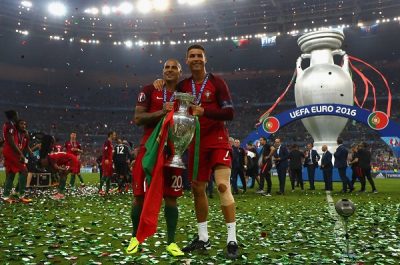 Portugal's forward Eder (L), Portugal's defender Pepe, Portugal's defender Fonte pose with Portugal's forward Cristiano Ronaldo (R) as he holds the winners' trophy after beating France 1-0 in the Euro 2016 final