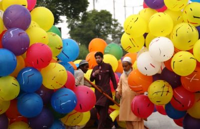 Pakistani men sell balloons after Eid prayers in Karachi. Photo: Rehan Khan/EPA