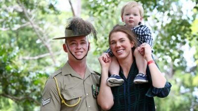 Australian Serviceman Corporal Tim McAllister of the 2/14 Light Horse Regiment with wife Olivia and two-year-old son Hamish after the Welcome Home Parade on Saturday morning. Photo: Lisa Maree Williams