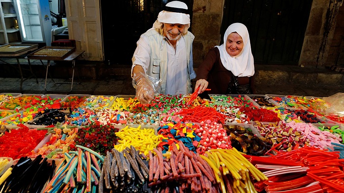 People buy sweets in Jerusalem's Old City before the Muslim holiday. Photo: Ammar Awad/Reuters