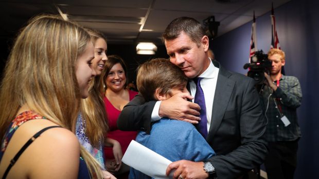 Premier Mike Baird embraces his family after the press conference announcing his resignation. Photo: Janie Barrett