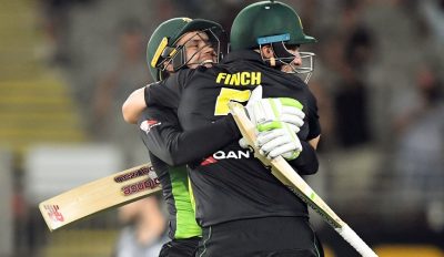 Alex Carey and Aaron Finch embrace to celebrate Australia’s record-breaking victory. Photograph: Ross Setford/AAP